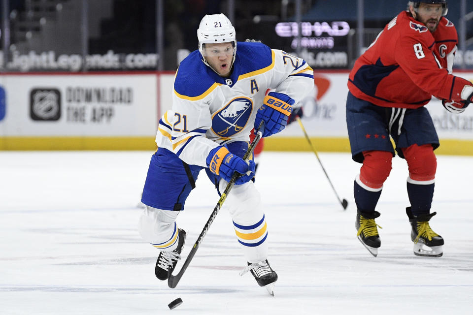 FILE - In this Feb. 18, 2021, file photo, Buffalo Sabres right wing Kyle Okposo (21) skates with the puck during the first period of an NHL hockey game against the Washington Capitals in Washington. (AP Photo/Nick Wass, File)
