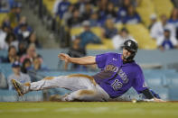 Colorado Rockies' Sean Bouchard (12) scores off of a single hit by Michael Toglia during the ninth inning of a baseball game against the Los Angeles Dodgers in Los Angeles, Monday, Oct. 3, 2022. (AP Photo/Ashley Landis)