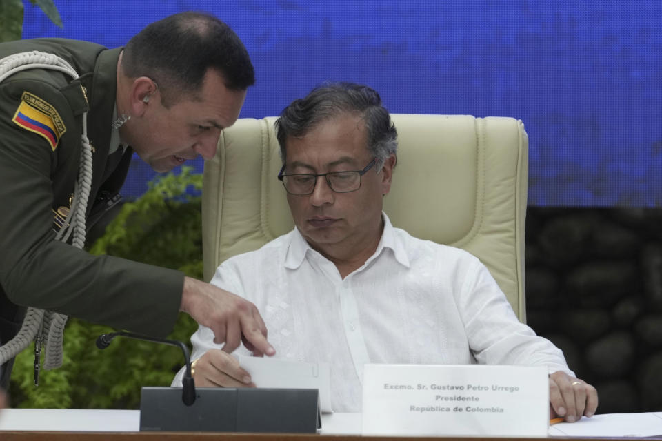 Colombia's President Gustavo Petro listens to a military aid during a bilateral ceasefire agreement signing ceremony between his government and the Colombian National Liberation Army (ELN) guerrilla, at El Laguito in Havana, Cuba, Friday, June 9, 2023. (AP Photo/Ramon Espinosa)