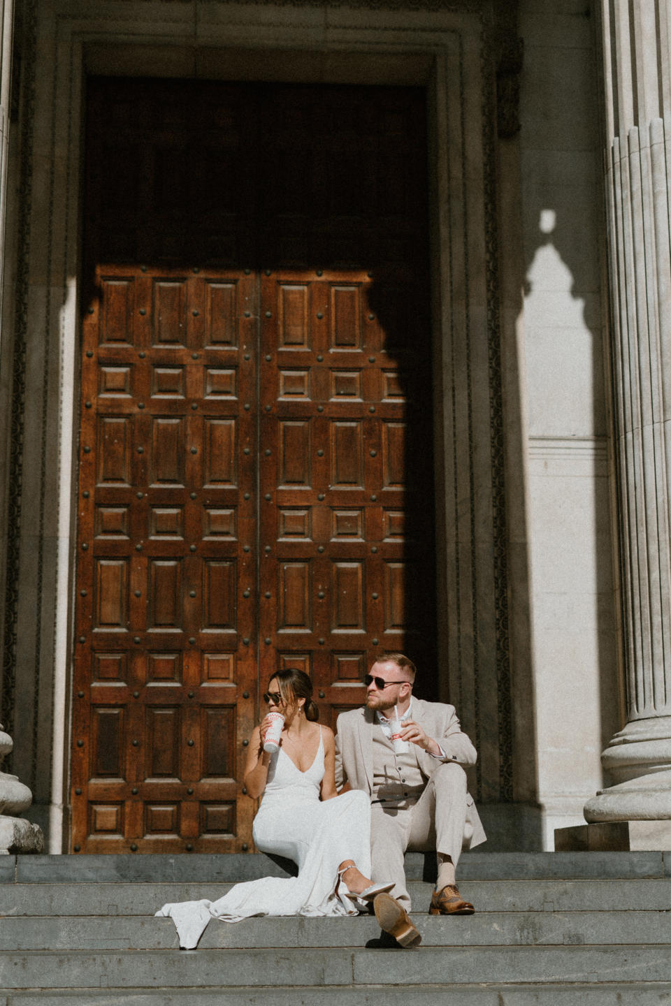 Bride and groom sat on steps