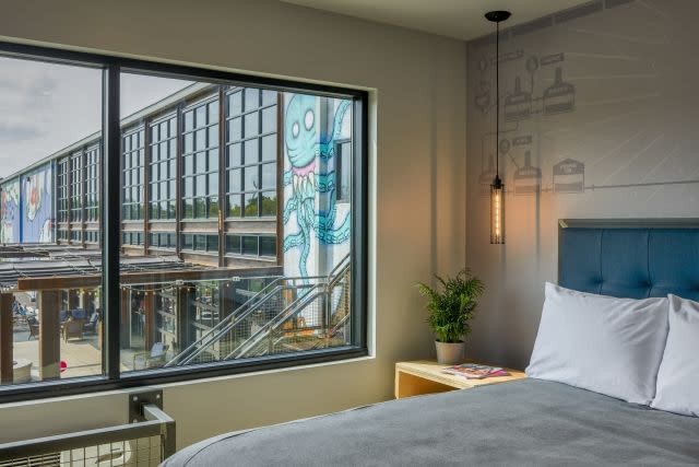 A bedroom overlooking the brewing facility a DogHouse hotel in Columbus, Ohio