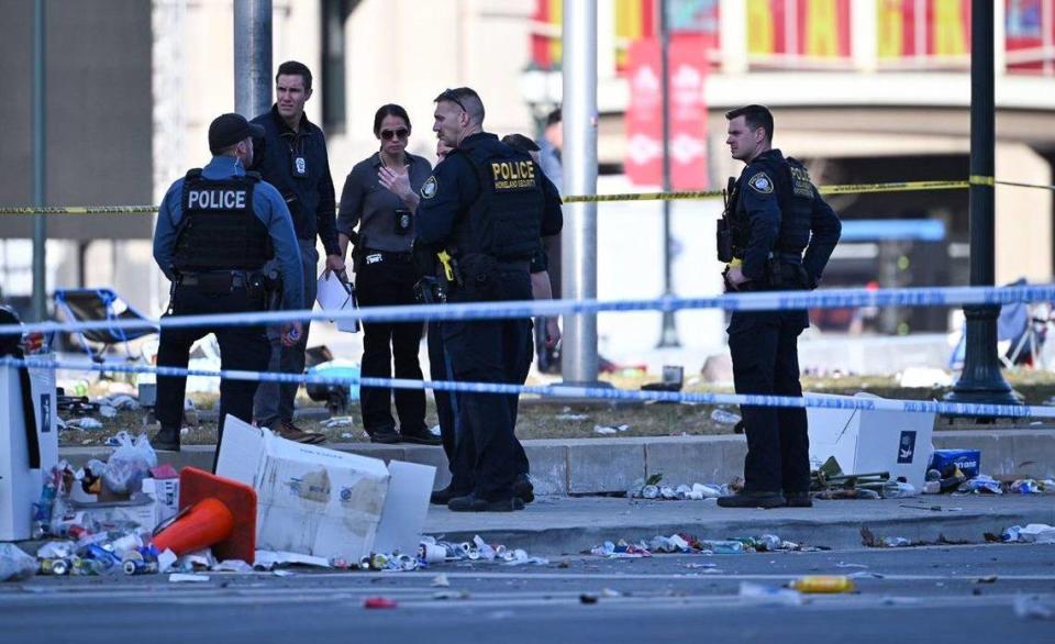 Police officers investigate the scene of a shooting where at least one person was killed and more than 20 others were injured after the Kansas City Chiefs Super Bowl LVIII victory parade Wednesday, Feb. 14, 2024, in Kansas City.