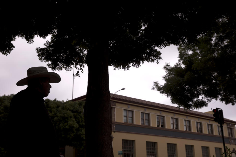 In this Wednesday, Sept. 5, 2018, photo, retired farmworker Alberto Alvarez is silhouetted as he strolls around downtown Salinas, Calif. Few cities exemplify California's housing crisis better than Salinas, an hour's drive from Silicon Valley and surrounded by farm fields. It's one of America's most unaffordable places to live, and many residents believe politicians lack a grip on the reality of the region's housing crisis. (AP Photo/Jae C. Hong)