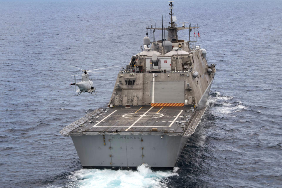 FILE - The USS Milwaukee, a Freedom-class of littoral combat ship, cruises underway as an MQ-8B Fire Scout unmanned aerial vehicle hovers during flight operations on June 27, 2019, in the Atlantic Ocean. The Navy that once wanted smaller, speedy warships to chase down pirates has made a speedy pivot to Russia and China and many of those ships, like the USS Milwaukee, could be retired. The Navy wants to decommission nine ships in the Freedom-class, warships that cost about $4.5 billion to build. (Mass Communication Specialist 2nd Class Anderson W. Branch/U.S. Navy via AP, File)