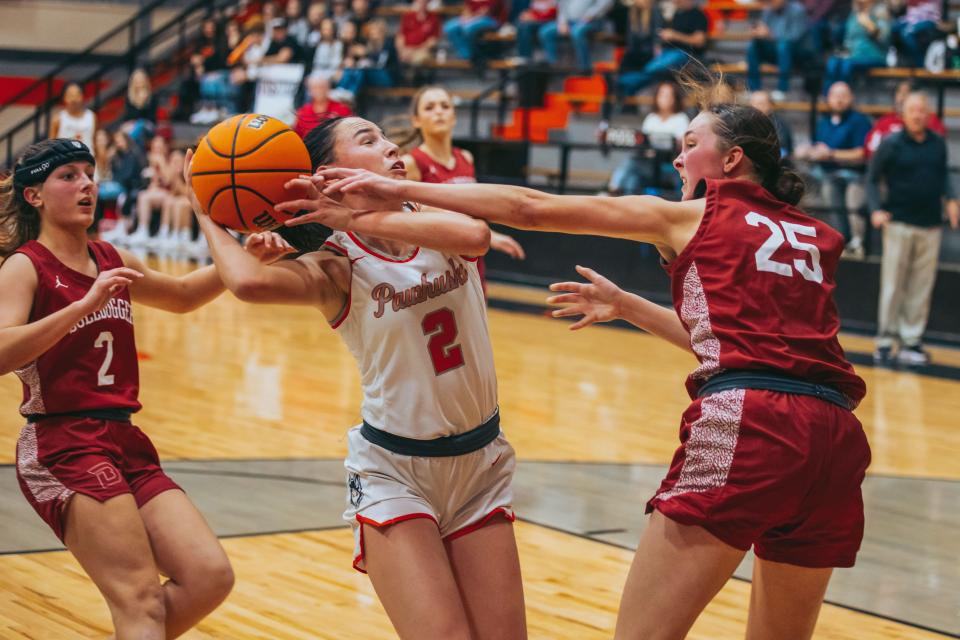 Pawhuska's Hannah Reynolds battles Dewey's Cheyanne McDaniel during action last season.