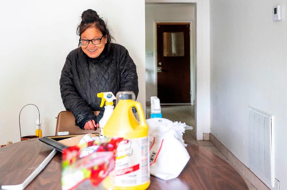 Despite an incredibly difficult and harrowing month, Helen Wong still keeps a smile on her face while a crew of several kind-hearted volunteers work on deep cleaning her home on Thursday afternoon in Lewiston.