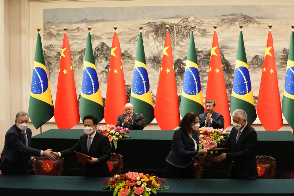 Brazilian President Luiz Inacio Lula da Silva, top left, and Chinese President Xi Jinping applaud during a signing ceremony held at the Great Hall of the People in Beijing, China, Friday, April 14, 2023. (Ken Ishii/Pool Photo via AP)