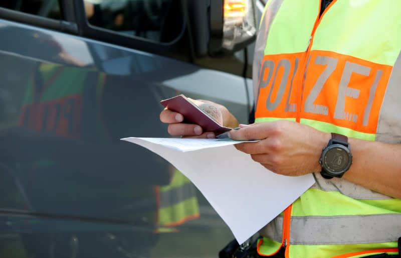 FILE PHOTO: Bavarian Police Officers control cars at a temporarily checkpoint on the motorway between the Austrian and German border in Kirchdorf am Inn