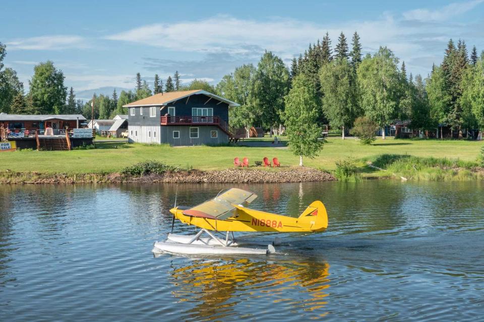 Small yellow plane on water in Alaska