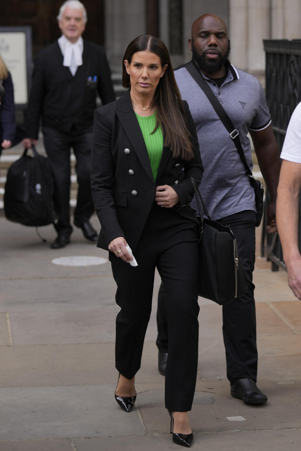 Rebekah Vardy departs the High Court in London, Thursday, May 19, 2022. A trial involving a social media dispute between two soccer spouses has opened in London. Rebekah Vardy sued for libel after Coleen Rooney accused her of sharing her private social media posts with The Sun newspaper. (AP Photo/Alastair Grant)