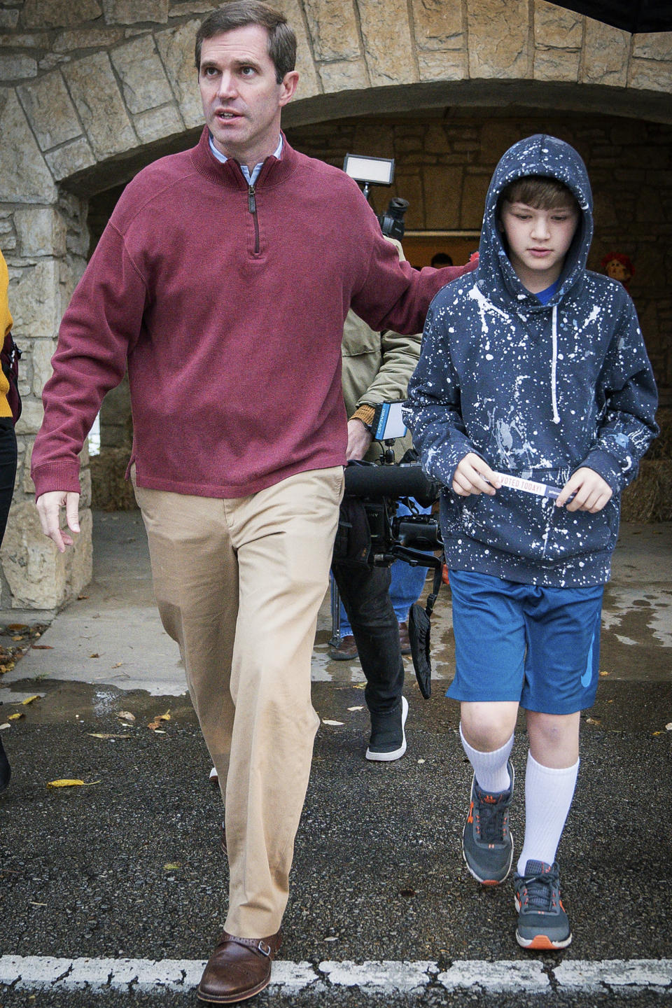 Kentucky Attorney General and Democratic Gubernatorial Candidate Andy Beshear, and his son Will, 10, depart the Knights of Columbus polling location, Tuesday, Nov. 5, 2019, in Louisville, Ky. (AP Photo/Bryan Woolston)