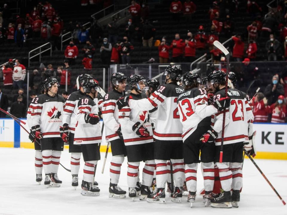 Canada celebrates its victory over Austria at the world junior hockey tournament in Edmonton on Tuesday. The tournament was cancelled on Wednesday as more players tested positive for COVID-19. (Jason Franson/The Canadian Press - image credit)