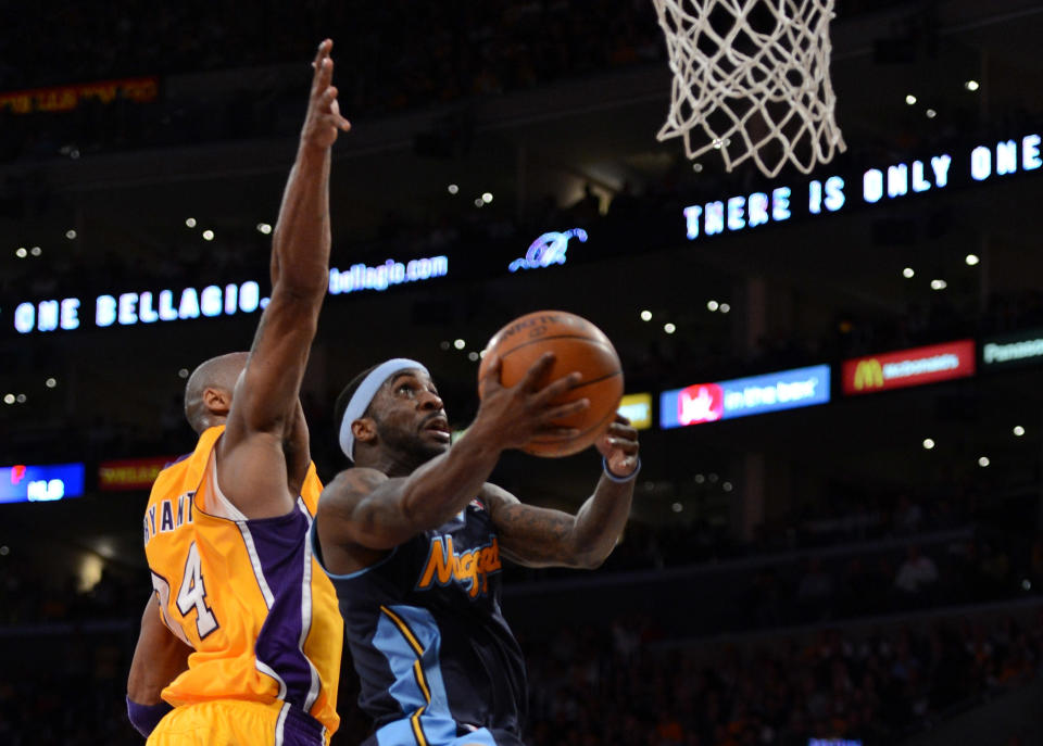 LOS ANGELES, CA - MAY 12: Ty Lawson #3 of the Denver Nuggets lays the ball up in front of Kobe Bryant #24 of the Los Angeles Lakers in the second half in Game Seven of the Western Conference Quarterfinals in the 2012 NBA Playoffs on May 12, 2012 at Staples Center in Los Angeles, California. NOTE TO USER: User expressly acknowledges and agrees that, by downloading and or using this photograph, User is consenting to the terms and conditions of the Getty Images License Agreement. (Photo by Harry How/Getty Images)