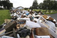 Bulky Piles of waste goods line a street after floods destroyed many homes in the village of Stotzheim, Germany, Thursday July 22, 2021. In the flood disaster area of Erftstadt-Blessem, some residents are being allowed back into their homes to clear debris after heavy rains caused devastating floods. (David Young/dpa via AP)