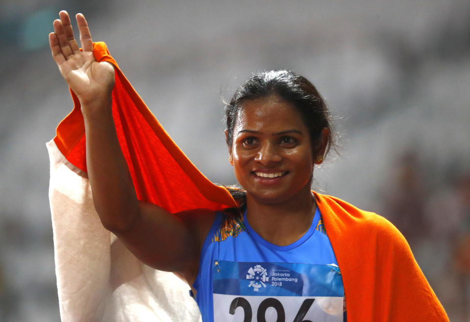 India's Dutee Chand celebrates after her second place finish in the women's 100m final during the athletics competition at the 18th Asian Games in Jakarta, Indonesia, Sunday, Aug. 26, 2018. (AP Photo/Bernat Armangue)