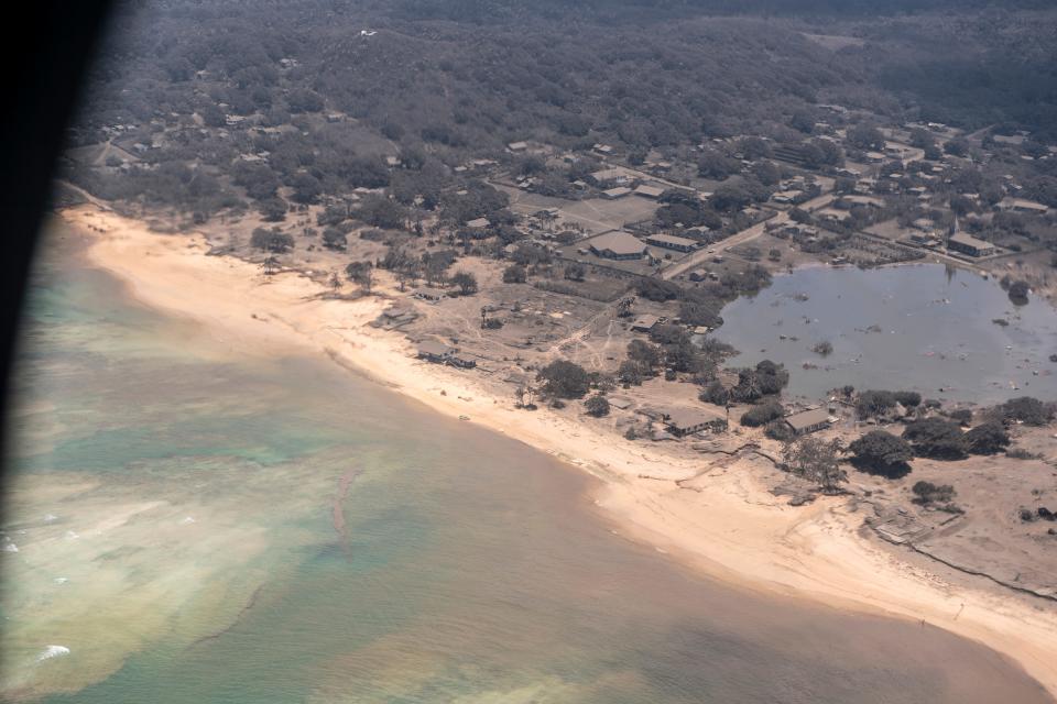 Volcanic ash covers roofs and vegetation in an area of Tonga on Jan. 17. Thick ash on an airport runway delayed aid deliveries to the Pacific island nation, where damage was reported days after a huge undersea volcanic eruption and tsunami.