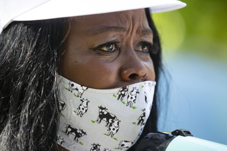 In this June 19, 2020, photo Jeannine Lee Lake, Democratic candidate for Indiana's 6th congressional district, fights her emotions as speaks to the crowd gathered for Juneteenth day event in Columbus, Ind. The Democrat, who lost badly in 2018 and again faces long odds in the deeply conservative district, has spent much of the past few weeks at events like the one in Columbus, Indiana, on Juneteenth. In communities across a district that is 93% white, Lake has talked about seeing her children pulled over by police and “harassed for no reason.” She has spoken the names of George Floyd, Breonna Taylor and other Black people killed by police, telling crowds “we’re here to call for change.” (AP Photo/Michael Conroy)