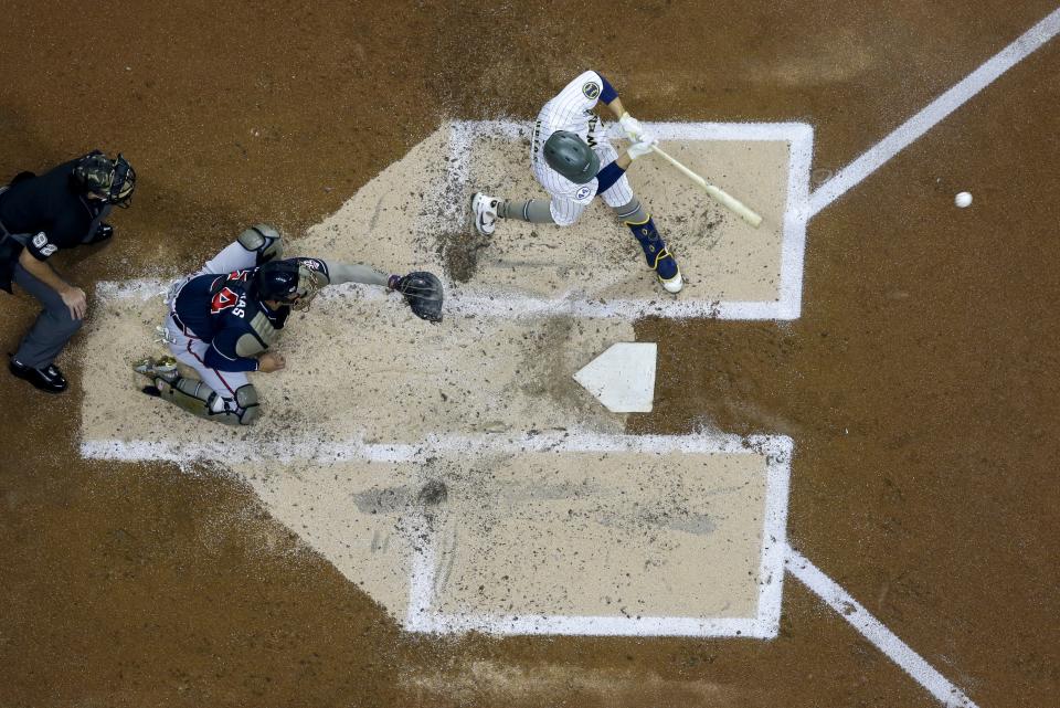 Milwaukee Brewers' Luis Urias hits an RBI single during the second inning of a baseball game against the Milwaukee Brewers Friday, May 14, 2021, in Milwaukee. (AP Photo/Morry Gash)