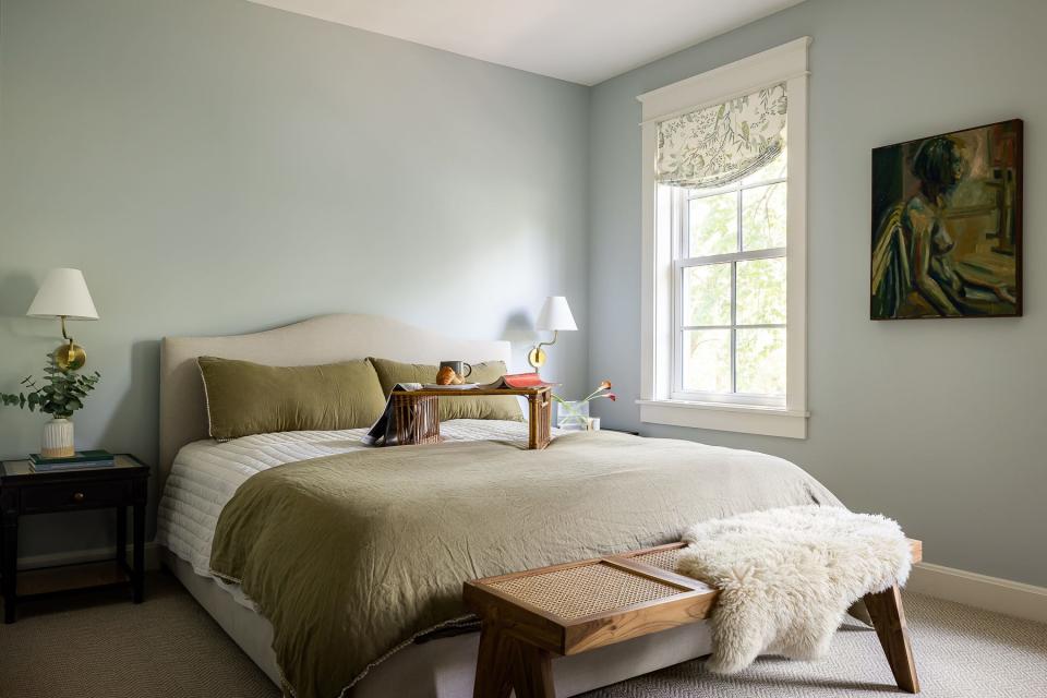 Inspiration for the primary bedroom color scheme was drawn from the hand-painted window coverings at this renovated American Foursquare Craftsman home in Old Louisville.