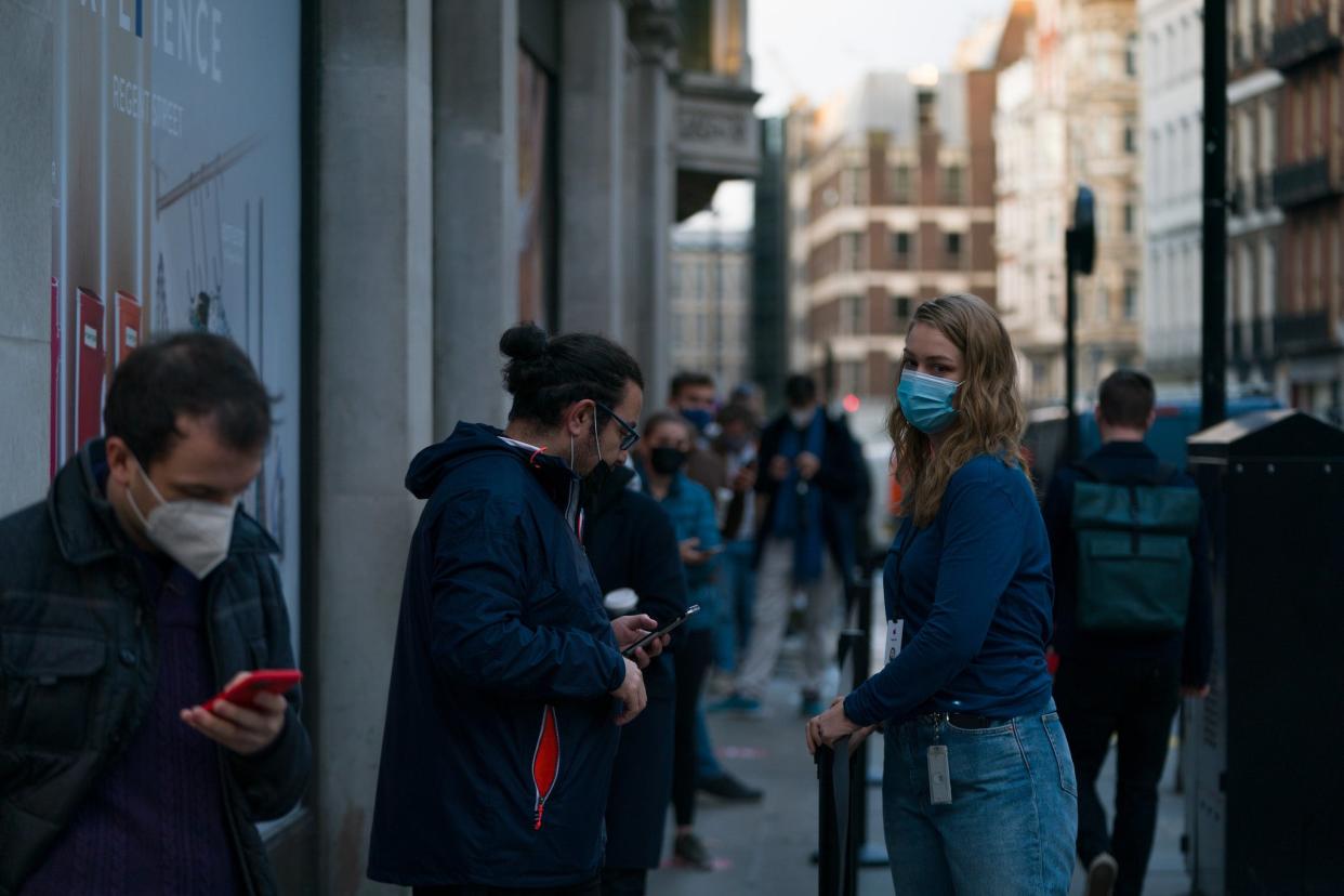Customers socially distance as they queue for the new iPhone 12 and iPhone 12 Pro on launch day on October 23 in London (Getty Images)
