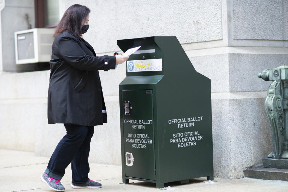 A voter casts her early voting ballot at drop box outside of City Hall on October 17, 2020 in Philadelphia, Pennsylvania.  (Mark Makela/Getty Images)