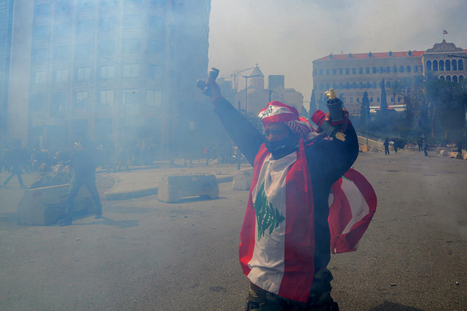 A protester holds a tear gas canister fired by riot police during a protest against the worsening political and economic crises in the country amid a plunge in the local pound, March 22, 2023, in Beirut, Lebanon. / Credit: Marwan Naamani/picture alliance via Getty