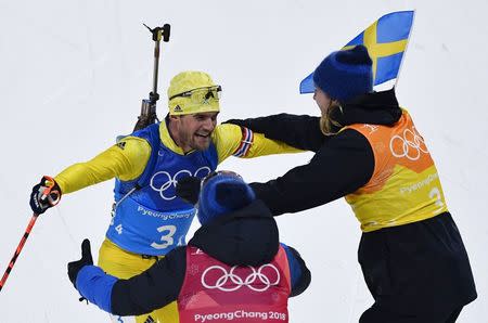 Biathlon - Pyeongchang 2018 Winter Olympics - Men's 4x7.5 km Relay Final - Alpensia Biathlon Centre - Pyeongchang, South Korea - February 23, 2018 - Fredrik Lindstroem of Sweden celebrates with team mates. REUTERS/Toby Melville