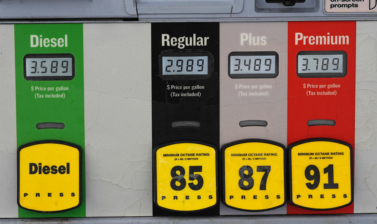 The price per gallon of the various grades of gasoline available are illuminated on a pump at a convenience store, Thursday, March 14, 2024, in Denver. (AP Photo/David Zalubowski)