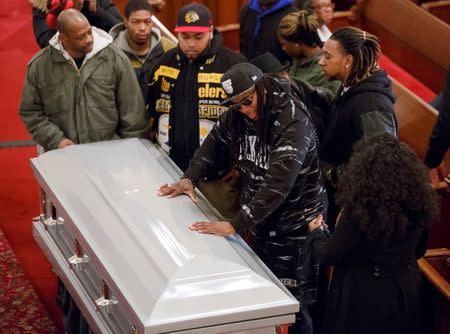 Friends of Akai Gurley stand by his coffin during his wake at Brown Memorial Baptist Church in Brooklyn, New York December 5, 2014. REUTERS/The New York Times/Richard Perry/Pool