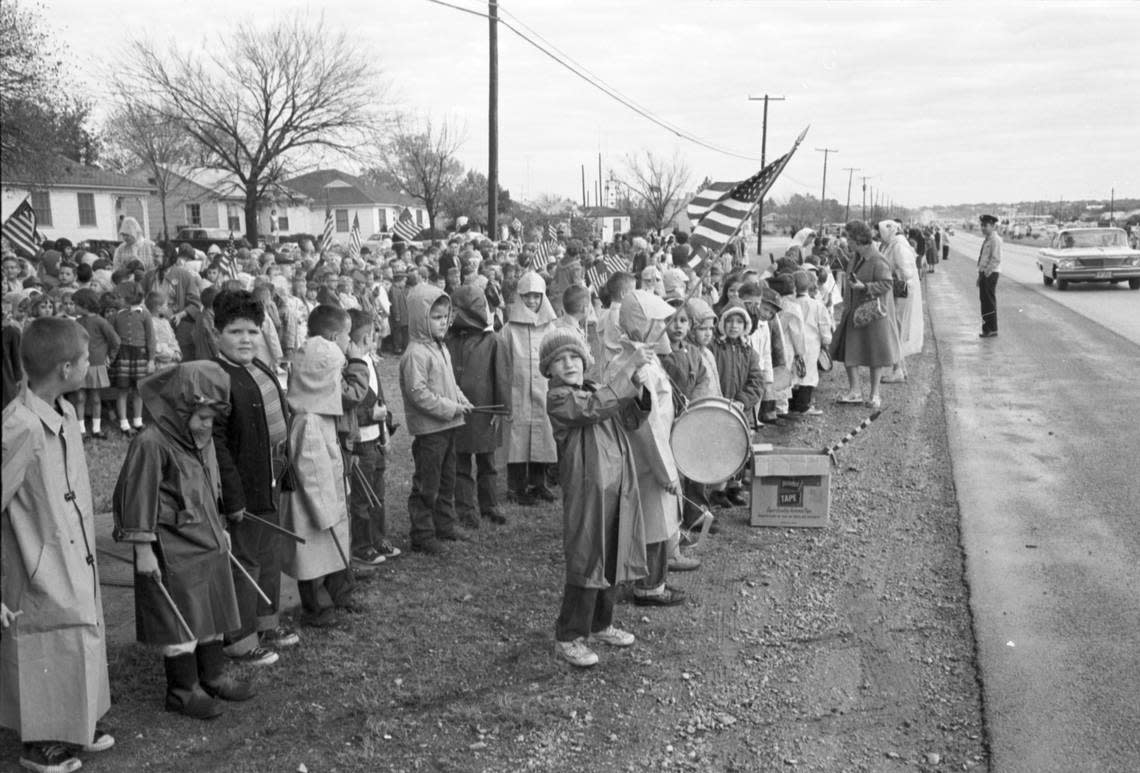 Fort Worth school children wait along River Oaks Boulevard for the motorcade with President John F. Kennedy and wife Jackie on their way to Carswell AFB to fly to Dallas, 11/22/1963