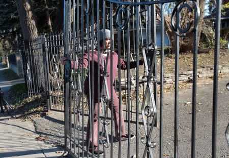 Monica Morgan, wife of U.S. Rep John Conyers, closes the gates in front of the family home in Detroit, Michigan, U.S., November 29, 2017. REUTERS/Rebecca Cook