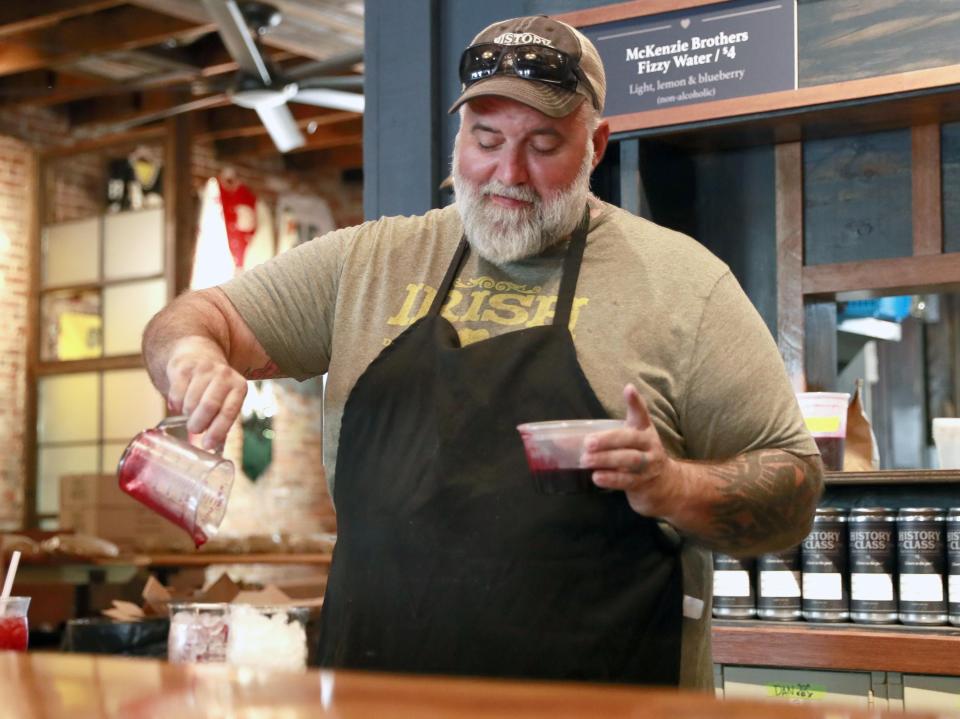 Dan Magner pours two glasses of McKenzie Brothers Fizzy Water at the History Class Brewing Co.