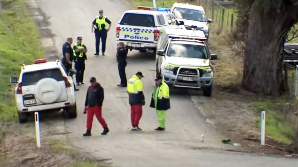 Police and paramedics, pictured here at the crash site at the Targa Tasmania.