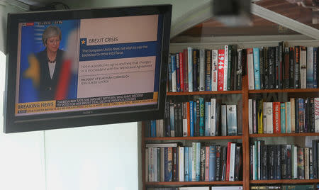 Britain's Prime Minister Theresa May is seen on a TV screen in a bar at Benavista Bowls Club in Estepona, southern Spain January 14, 2019. REUTERS/Jon Nazca