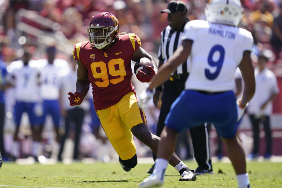 Southern California linebacker Drake Jackson (99) runs the ball after catching an interception during the first half of an NCAA college football game against San Jose State Saturday, Sept. 4, 2021, in Los Angeles. (AP Photo/Ashley Landis)