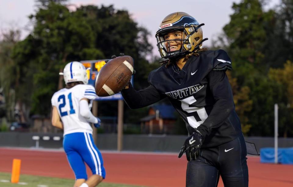 Capital junior wide receiver Marcellus Clay celebrates his second-quarter touchdown Friday against Timberline.