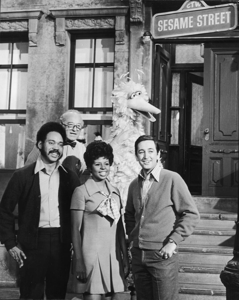 The show's first hosts, Matt Robinson (Gordon), Will Lee (Mr. Hooper), Loretta Long (Susan) and Bob McGrath (Bob), pose with <a href="https://people.com/tv/big-bird-puppeteer-retiring-sesame-street/" rel="nofollow noopener" target="_blank" data-ylk="slk:Big Bird;elm:context_link;itc:0;sec:content-canvas" class="link ">Big Bird</a> on the set of the educational public television series in 1969.