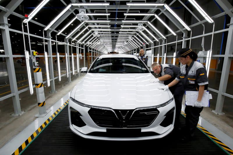 FILE PHOTO: Workers at Vinfast's auto plant on the occasion of its opening ceremony in Hai Phong city