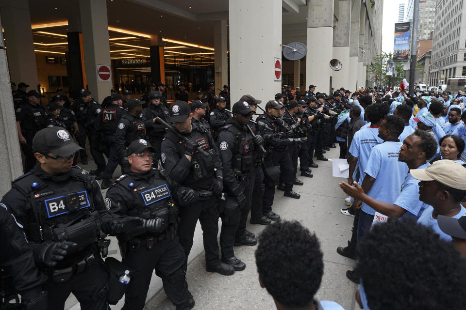 Toronto police work the scene of a protest outside of the Sheraton Hotel in downtown Toronto, on Sunday, Aug. 6 2023. The city of Toronto revoked the permit for an Eritrean cultural festival scheduled to run through the August long weekend after a number of violent clashes between participants and protesters sent nine people to hospital and stalled local traffic for hours. (Arlyn McAdorey/The Canadian Press via AP)