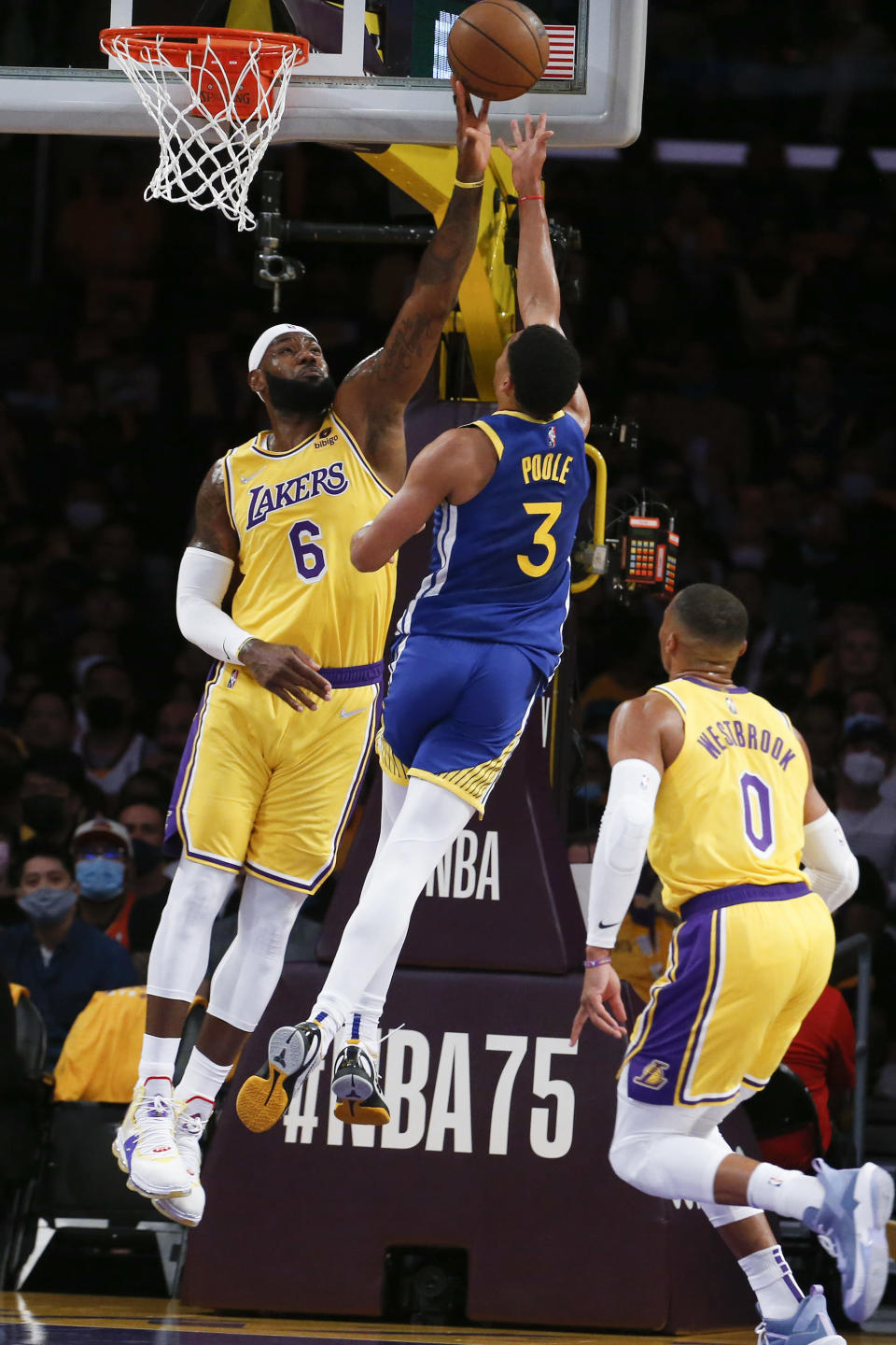 Los Angeles Lakers forward LeBron James (6) blocks a shot by Golden State Warriors guard Jordan Poole (3) during the first half of an NBA basketball game in Los Angeles, Tuesday, Oct. 19, 2021. (AP Photo/Ringo H.W. Chiu)