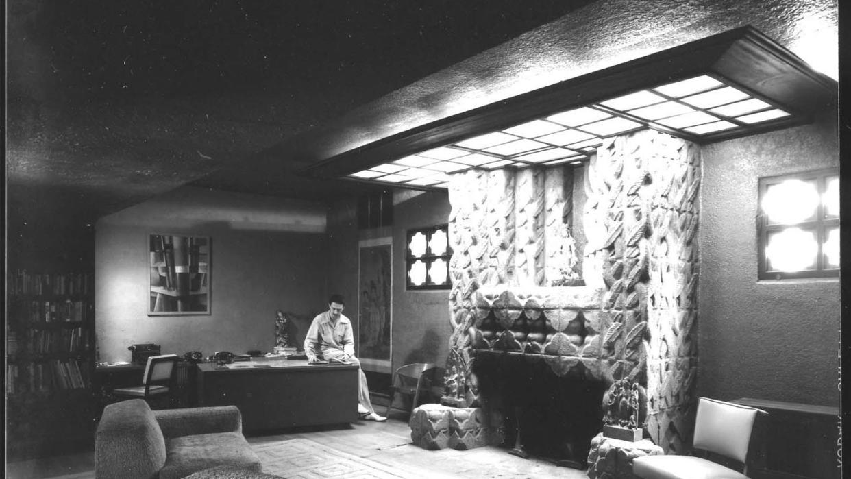 a person sitting at a desk in a room