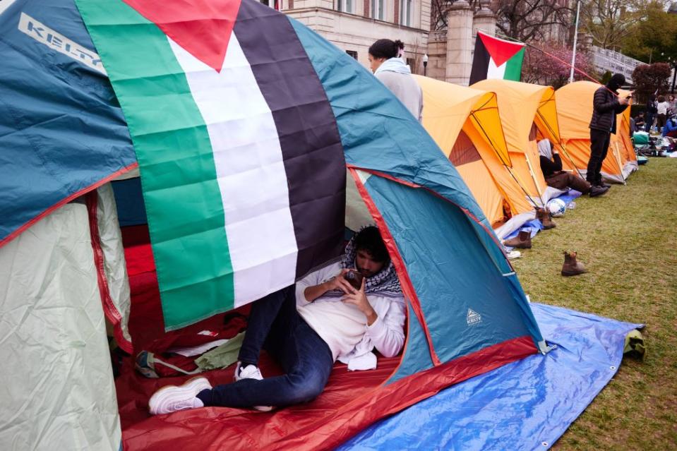 Pro-Palestinian demonstrators gather at an encampment on the lawn of Columbia University on Sunday, April 21. James Keivom