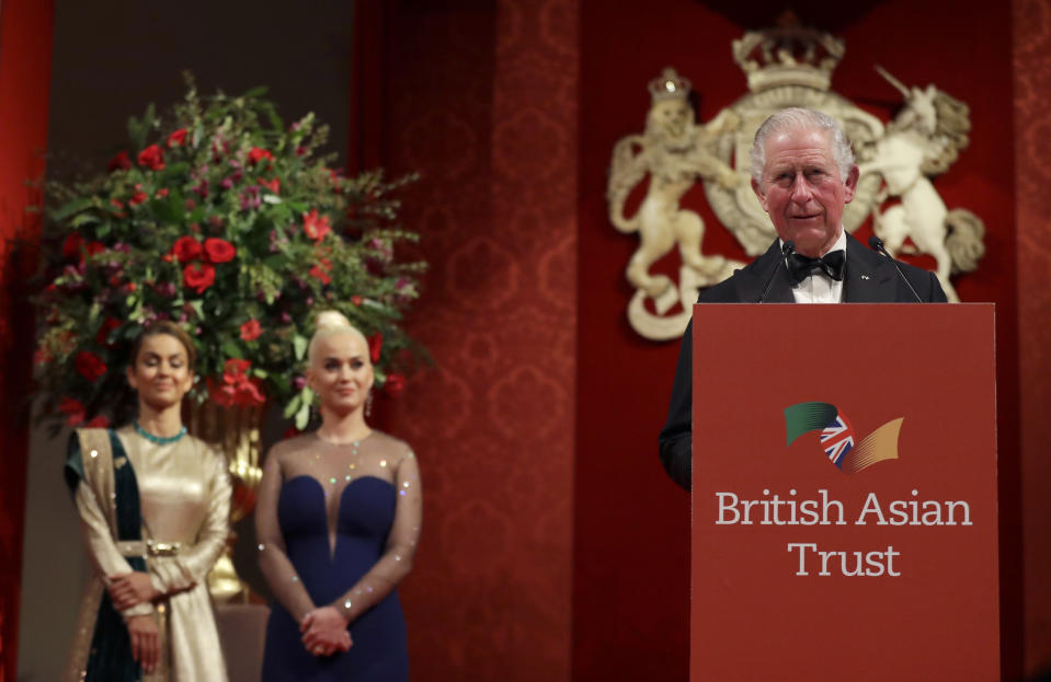 Katy Perry, center, and Natasha Poonawalla, listen as Britain's Charles, Royal Founding Patron of the British Asian Trust, gives a speech as he attends a reception for supporters of the British Asian Trust in London, Tuesday, Feb. 4, 2020. (AP Photo/Kirsty Wigglesworth, pool)