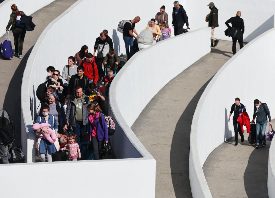 Ukrainians who were seeking asylum arrive at the U.S. port of entry in Tijuana, Mexico, in April 2022. <a href="https://www.gettyimages.com/detail/news-photo/ukrainians-who-are-seeking-asylum-walk-at-the-el-chaparral-news-photo/1390002303?adppopup=true" rel="nofollow noopener" target="_blank" data-ylk="slk:Mario Tama/Getty Images;elm:context_link;itc:0;sec:content-canvas" class="link ">Mario Tama/Getty Images</a>