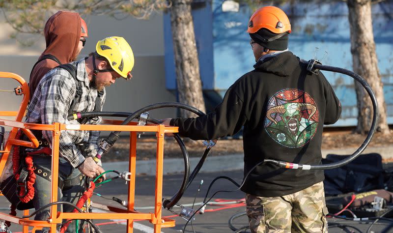 A crew from Verizon installs 5G equipment on a tower in Orem