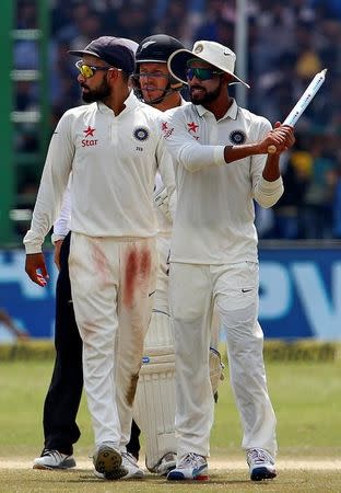 Cricket - India v New Zealand - First Test cricket match - Green Park Stadium, Kanpur - 26/09/2016. India's Ravindra Jadeja (R) and Virat Kohli walk off the field after winning the match. REUTERS/Danish Siddiqui