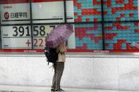 A person looks at an electronic stock board showing Japan's Nikkei index at a securities firm, Wednesday, Oct. 9, 2024, in Tokyo. (AP Photo/Eugene Hoshiko)