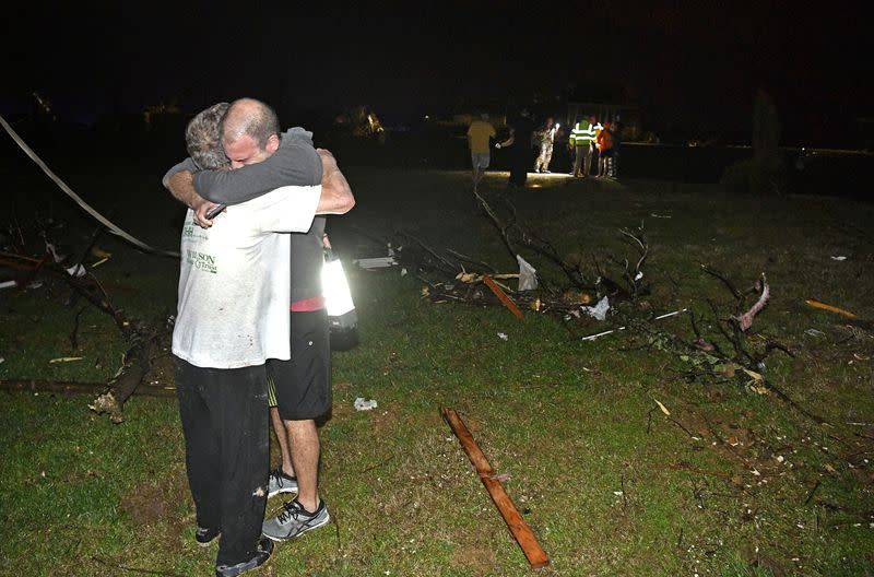 Billy Wallace hugs his dad Bill after a tornado ripped through Bill’s neighborhood destroying his home in Mt. Juliet