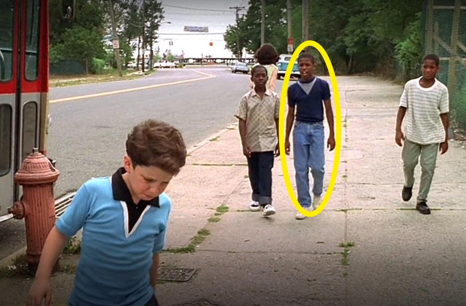 A young Michael circled and walking down the street with several other boys