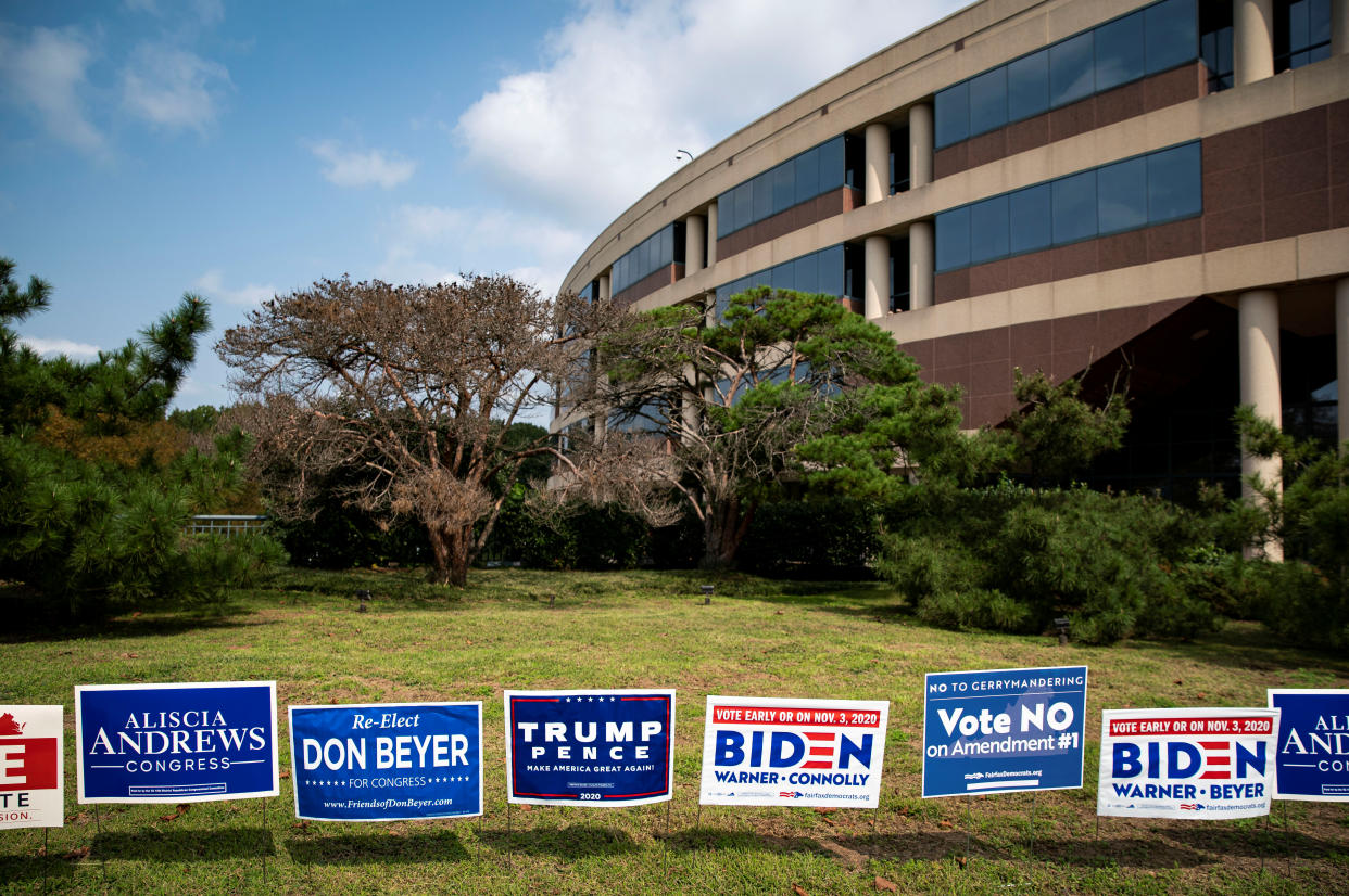 Yard signs supporting U.S. President Donald Trump and Democratic U.S. presidential nominee and former Vice President Joe Biden are seen during early voting for the 2020 U.S. presidential election at the Fairfax County Government Center in Fairfax, Virginia, U.S., September 18, 2020. REUTERS/Al Drago